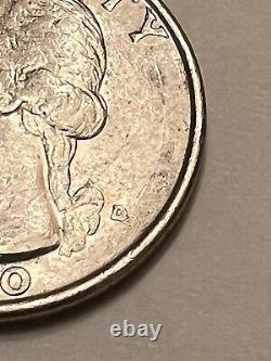 Silver 25 Cent Quarter of 1990 D, in regular condition. Botched Mint Mark
